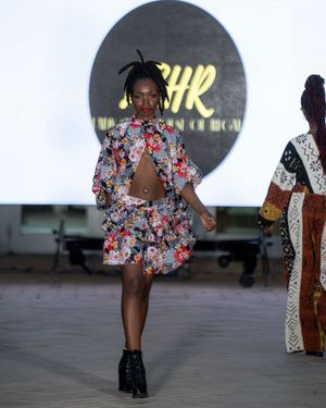 Model presents floral print outfit on runway at Columbia Museum fashion event.