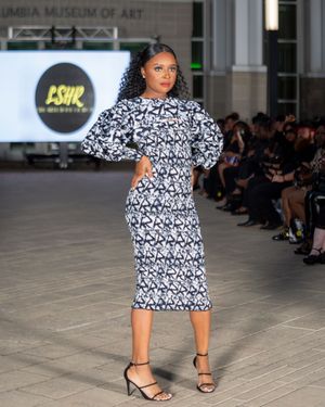 Black and white patterned midi dress with sandals shown at fashion week runway show.