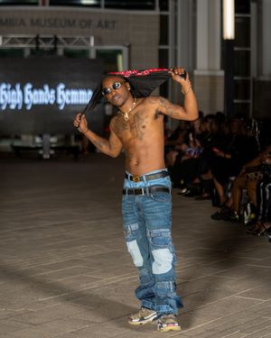 Denim streetwear look presented during Columbia Museum runway performance.