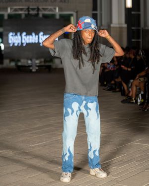 Denim with light blue paint splash effect displayed on industrial runway.