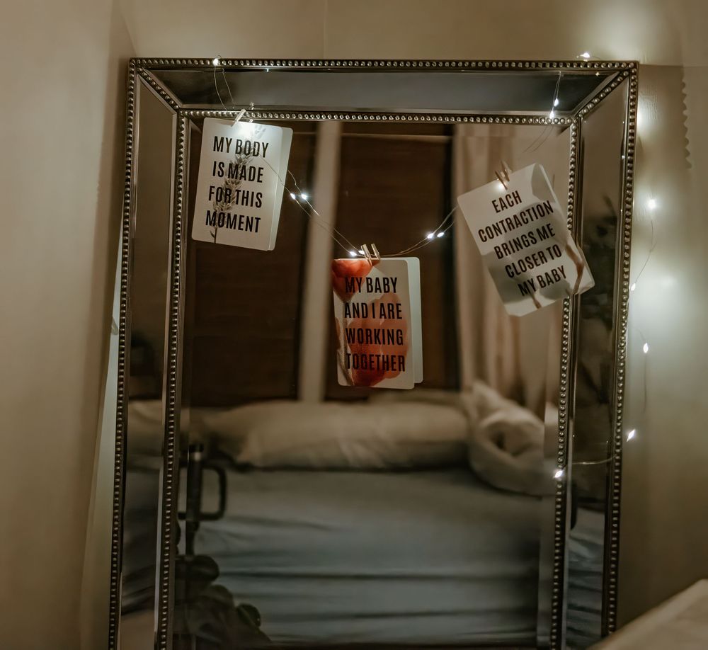 Motivational sticky notes posted on a mirror with a red drink can in the center.