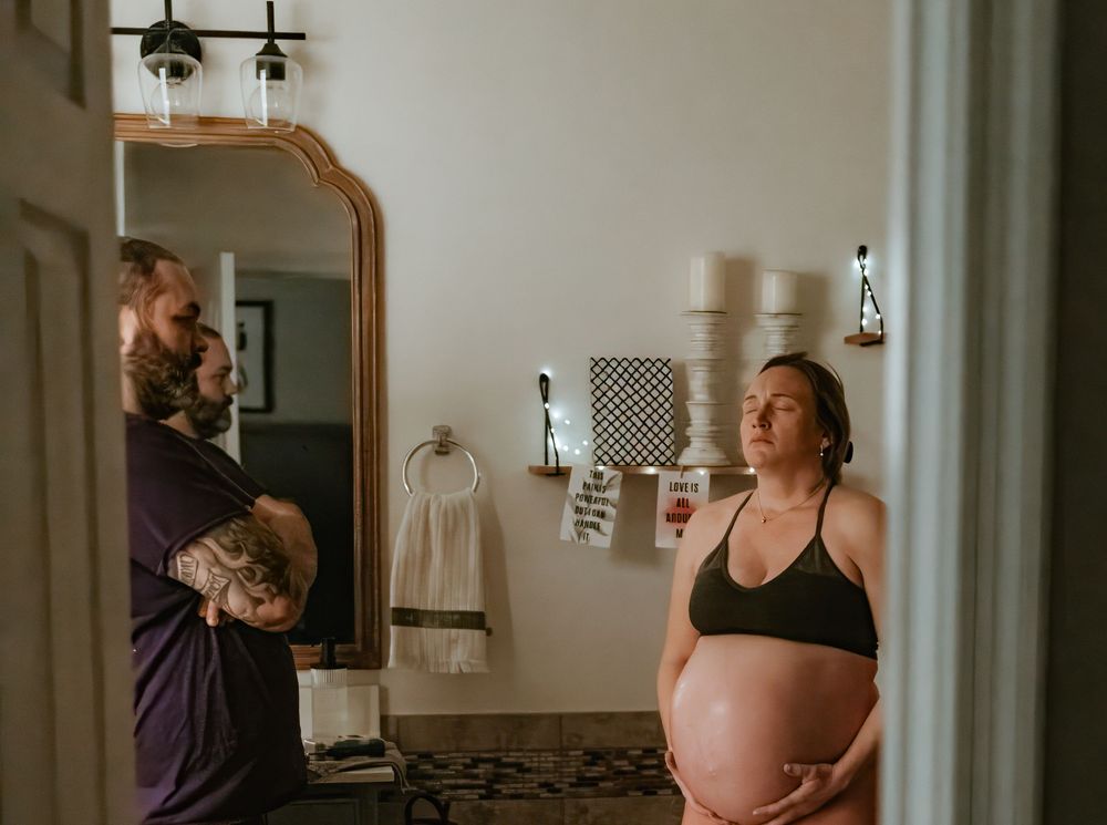 A series of four connected photos showing a maternity photoshoot in a naturally lit bedroom.