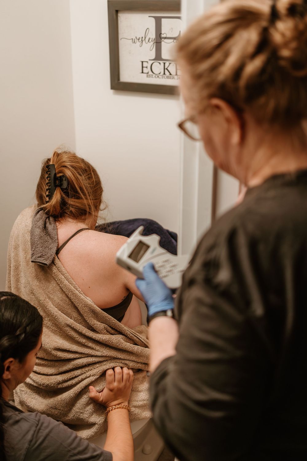 Close-up shots of a tattoo artist working on a client's arm in a professional studio environment.