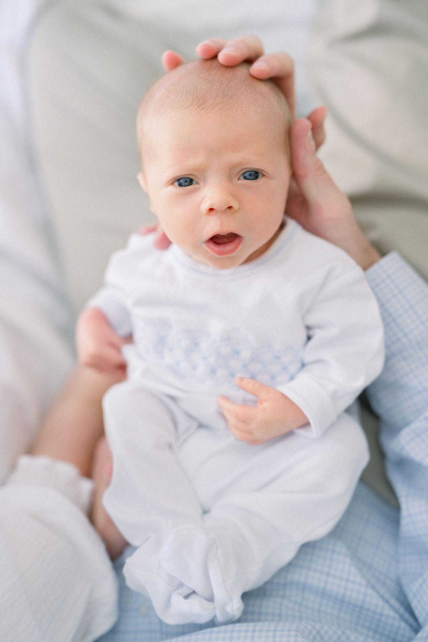 close up of newborn in father's hands at an in-home newborn session in Arlington, Virginia