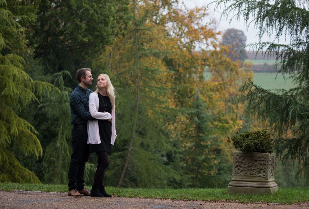 Couple embrace on hill of park in Tunbridge Wells in early Autumn