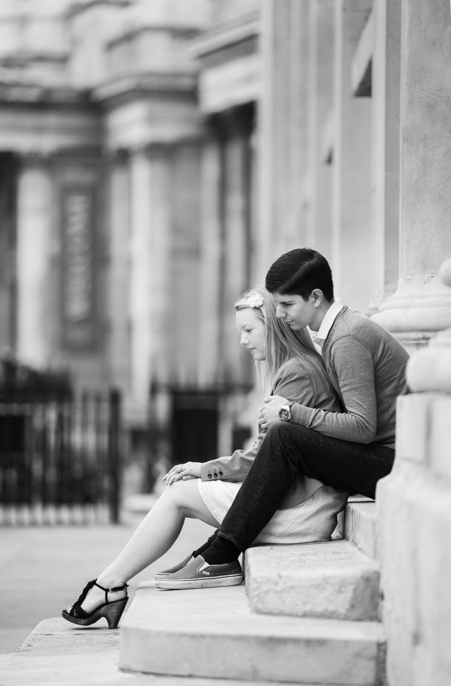 Couple elegantly sit on steps outside historic church