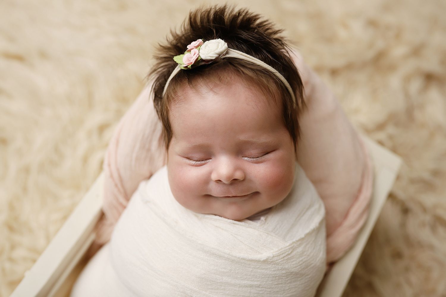 A series of four connected newborn photography portraits showing a sleeping baby wrapped in cream colored fabric. Utah baby photographer