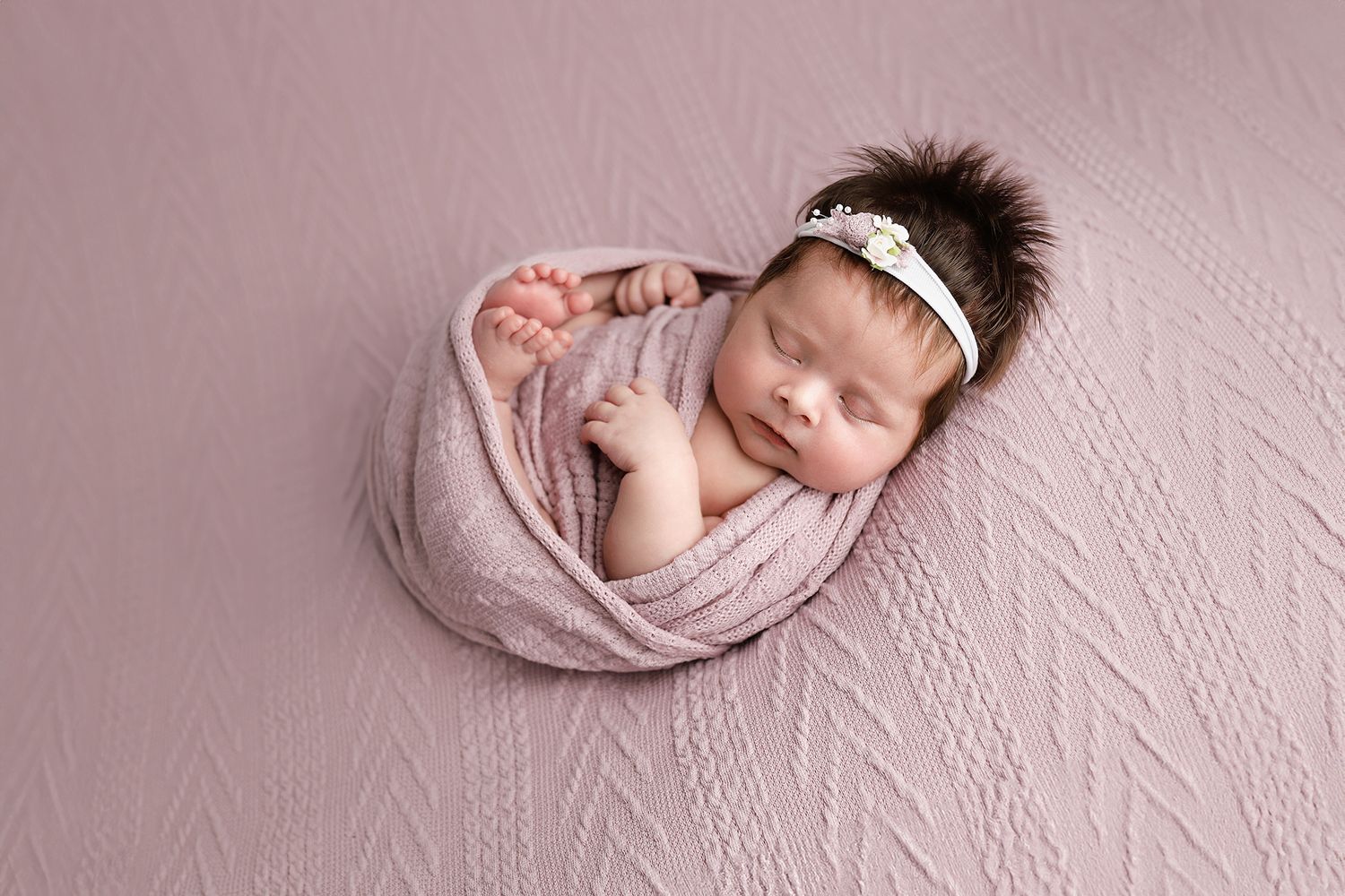 A collection of soft pink newborn photography portraits showing a sleeping baby wrapped in delicate fabric. Utah County newborn photographer