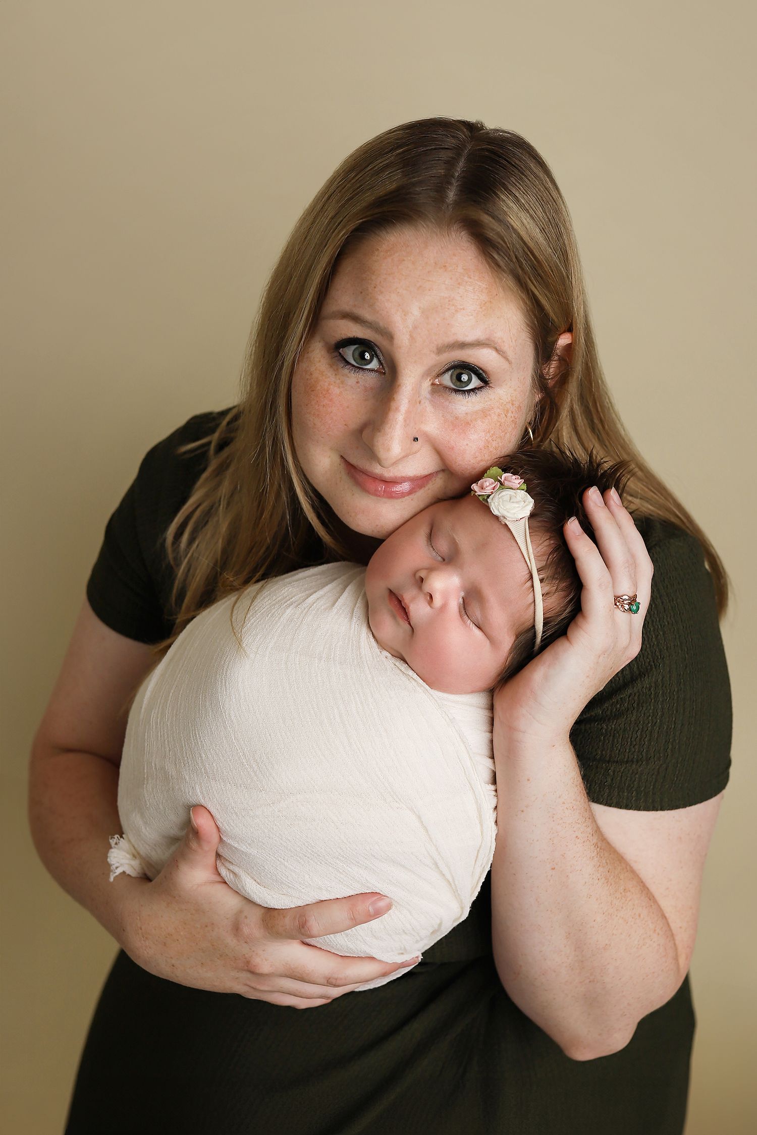 A series of five photos showing someone playfully posing with a white ball or sphere against a beige background. Utah County newborn photos