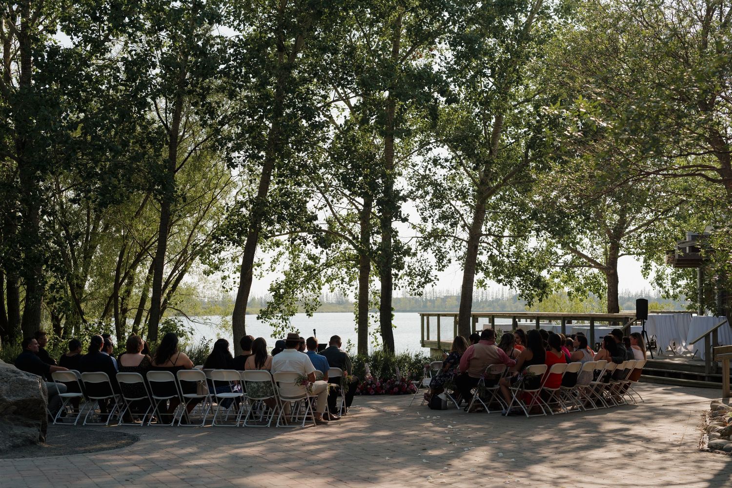 Panoramic sequence of a tree-lined path in a park with benches and dappled sunlight filtering through the canopy.