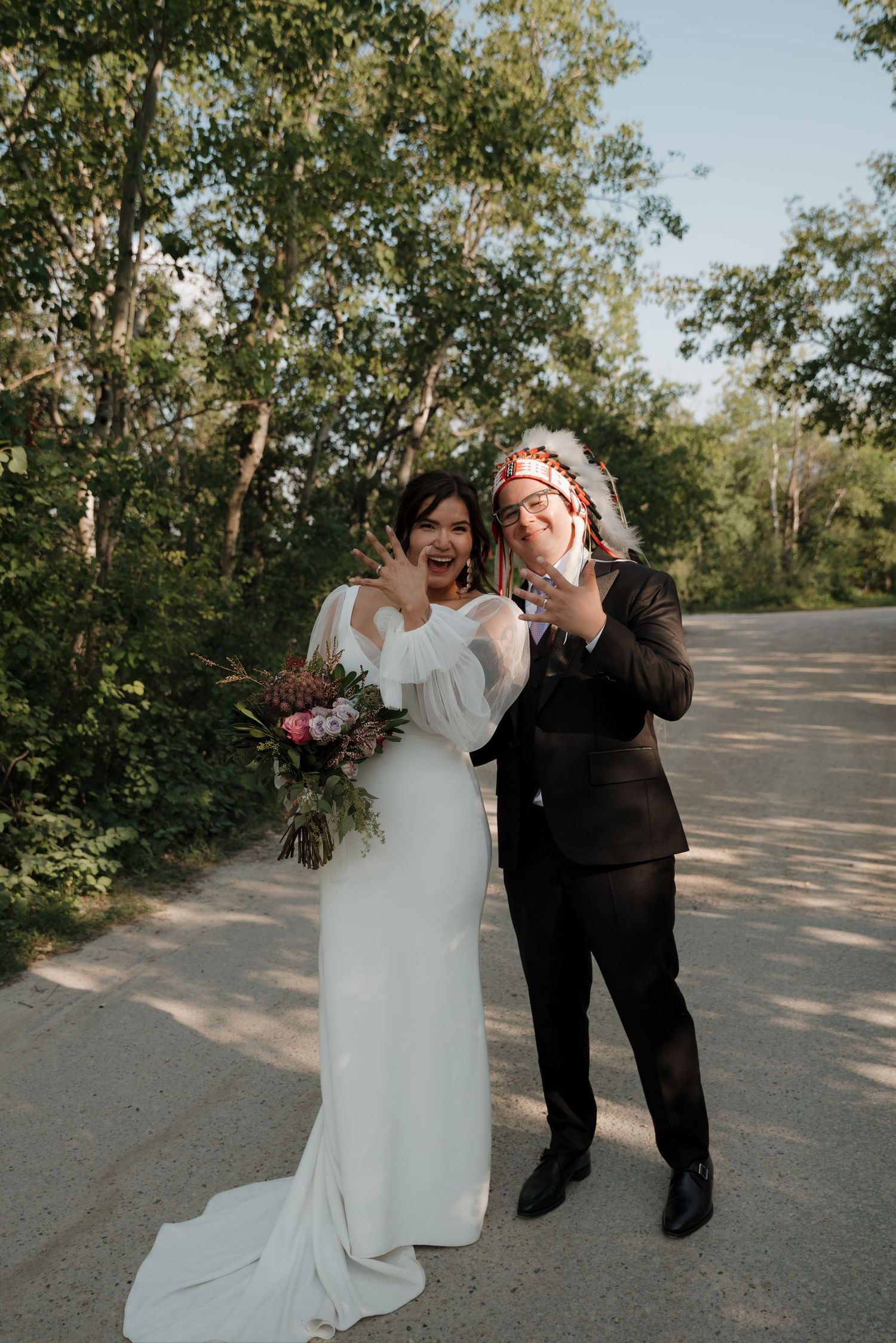 Wedding celebration outdoors with formal attire and natural woodland backdrop.