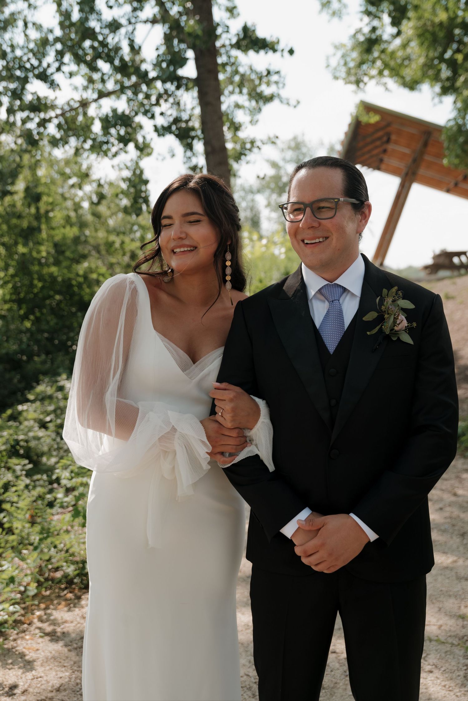 Couple shares a joyful moment together during their outdoor wedding ceremony.