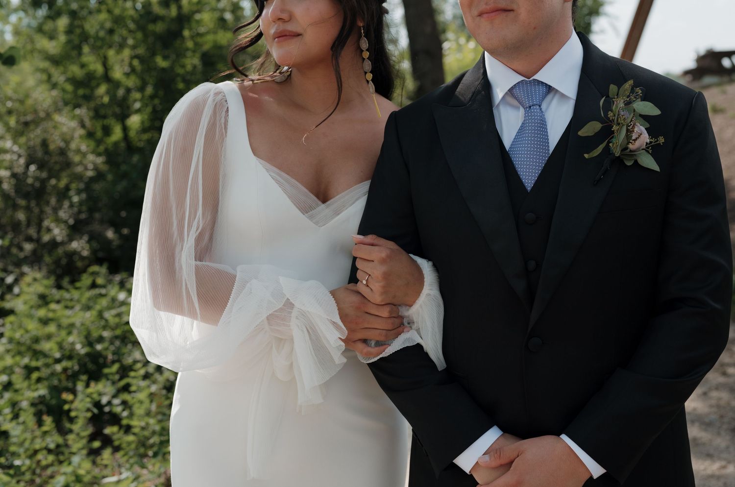 Close-up shots of a wedding couple sharing intimate moments together in an outdoor setting.