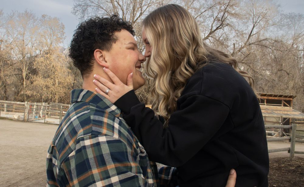 Couple holding each other during a romantic outdoor engagement session in Utah