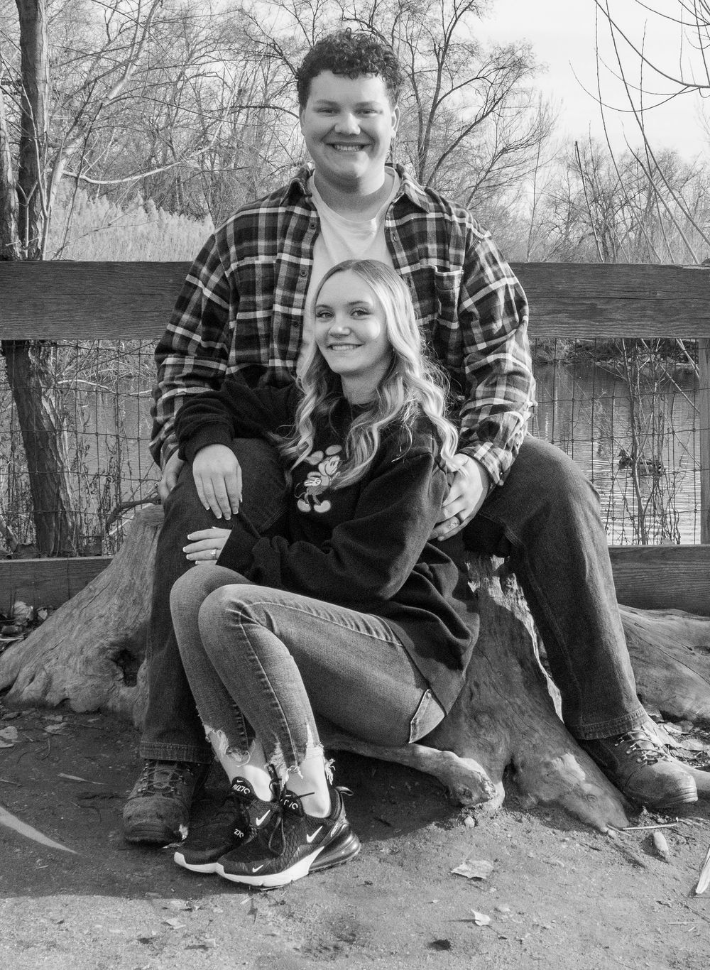 Couple sitting together during a candid black and white engagement photo session