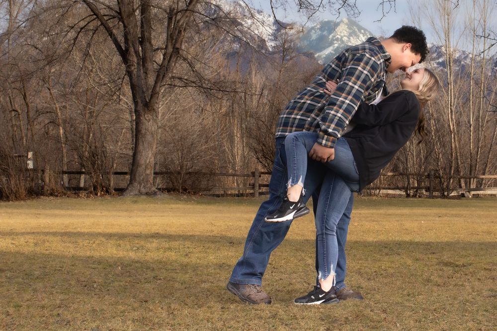 Couple laughing together during a playful outdoor engagement photo session