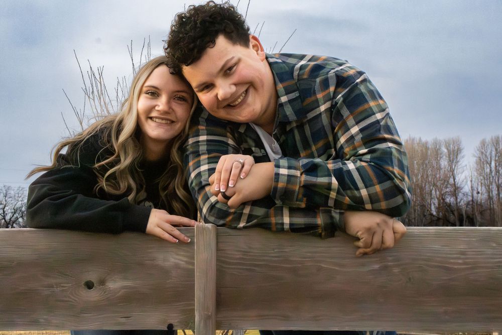 Couple smiling together during a relaxed outdoor engagement photo session