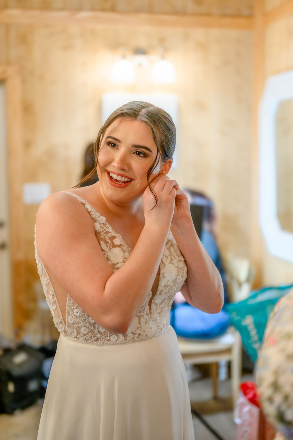 Elegant bridal portraits taken in a warm-lit preparation room.