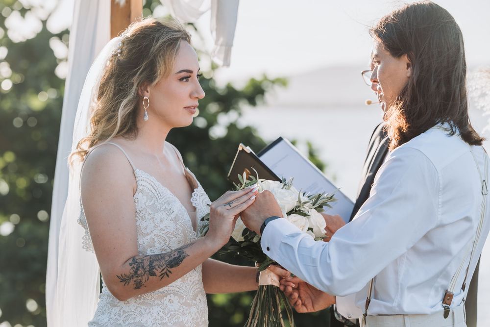 Wedding ceremony moments captured during vow exchanges by the ocean.