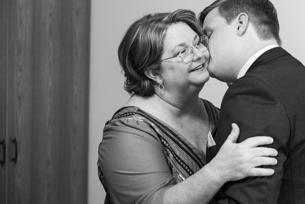 Tender moments shared between wedding party members during pre-ceremony preparations.