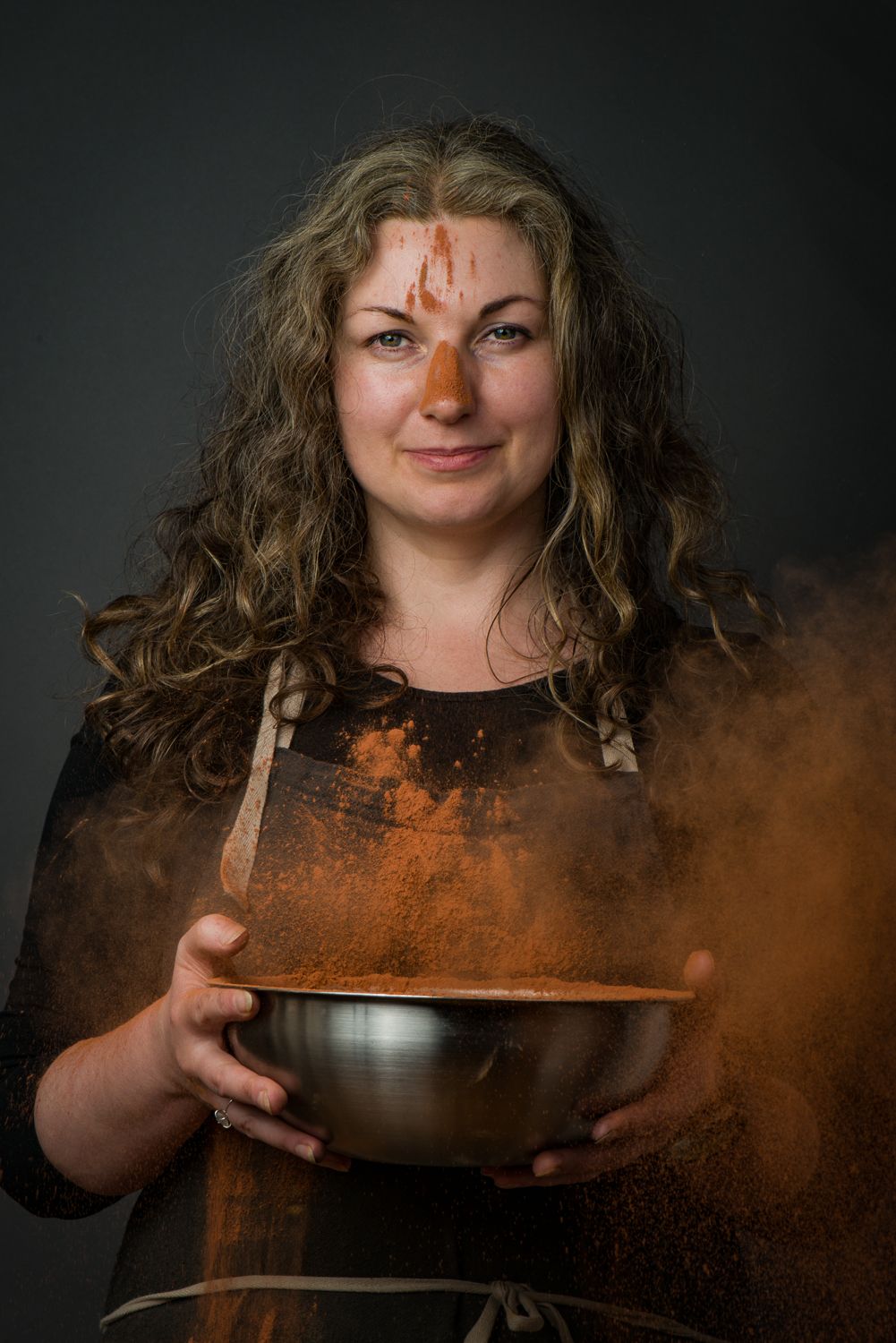 A series of photos showing hands holding a dark bowl with rising steam against a black background.