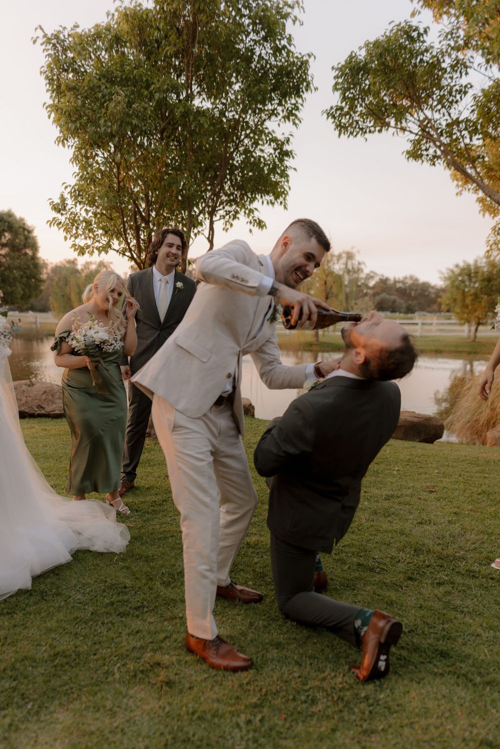A sequence of four wedding photos showing a playful wrestling move between people on grassy lawn at sunset.