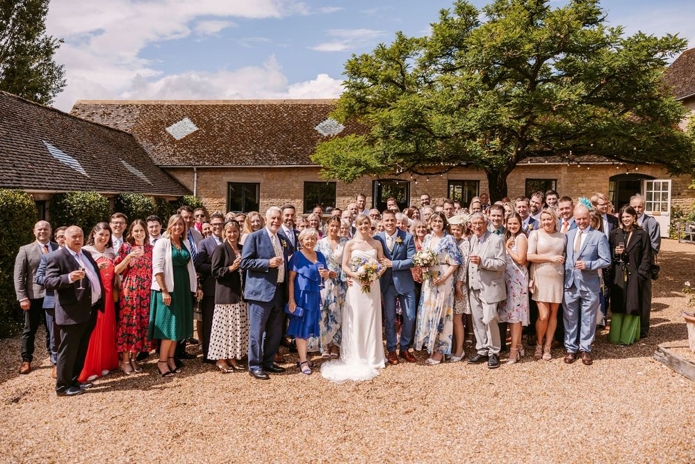 A panoramic sequence of outdoor wedding celebration photos showing large groups gathered at a rustic venue.