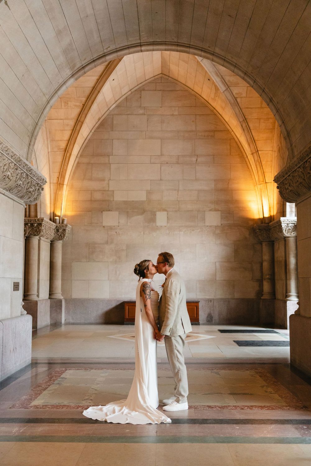 A romantic wedding photo sequence showing a couple in an elegant stone archway with warm lighting.