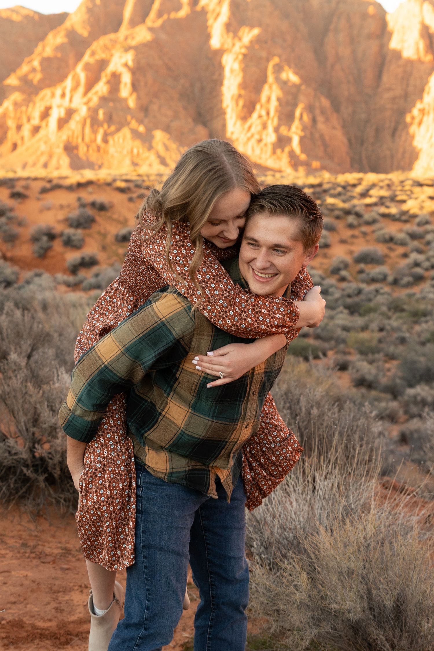 woman on piggy back wrapping arms around man smiling at each other