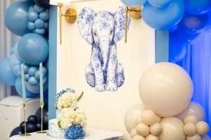 Blue and white balloon arch decorations with elegant silver accents create a stunning party backdrop display.