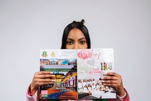 A series of photos showing someone holding up various books against a light background.