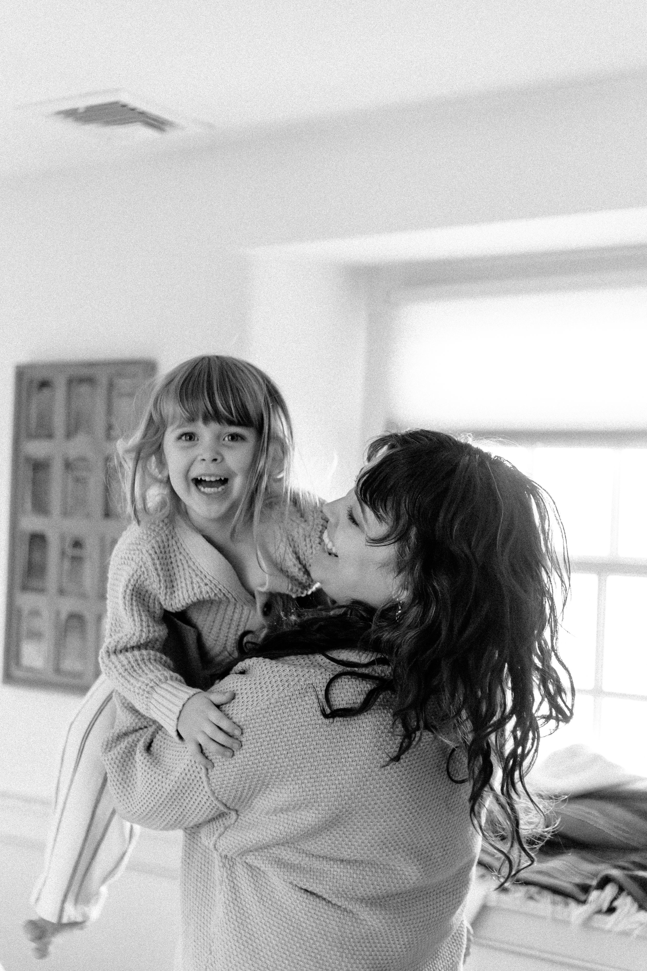 Two people share playful moments together in a bright indoor setting.