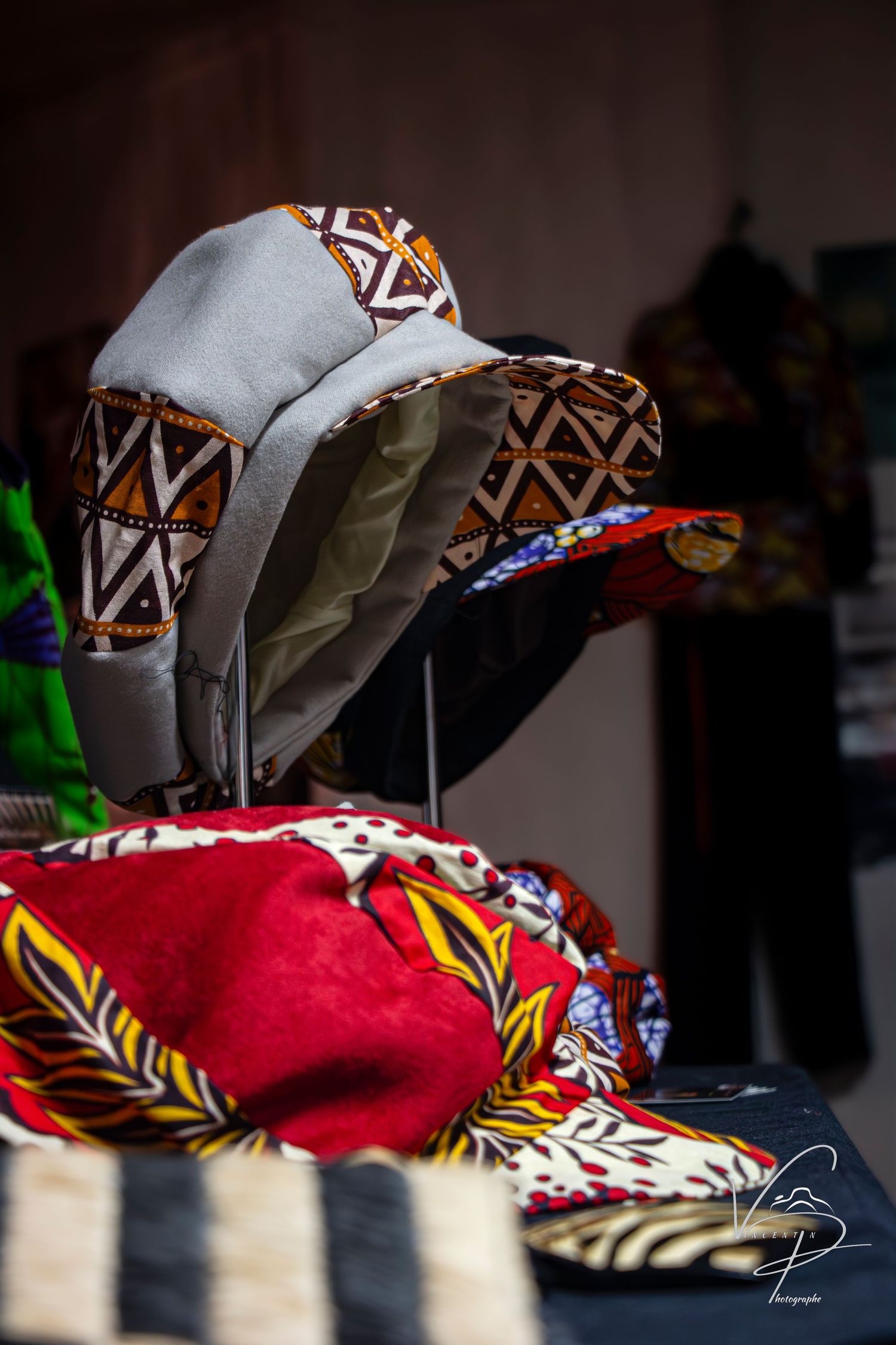 Colorful patterned fabric or clothing items arranged in soft focus.
