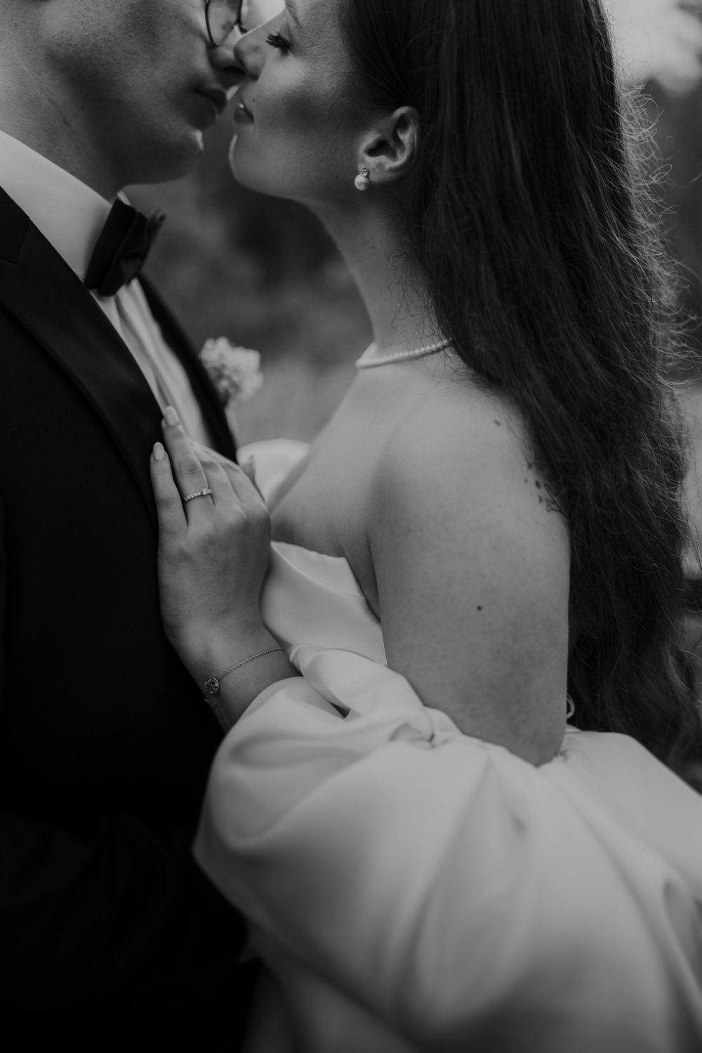 Intimate black and white portrait of couple sharing tender moment.