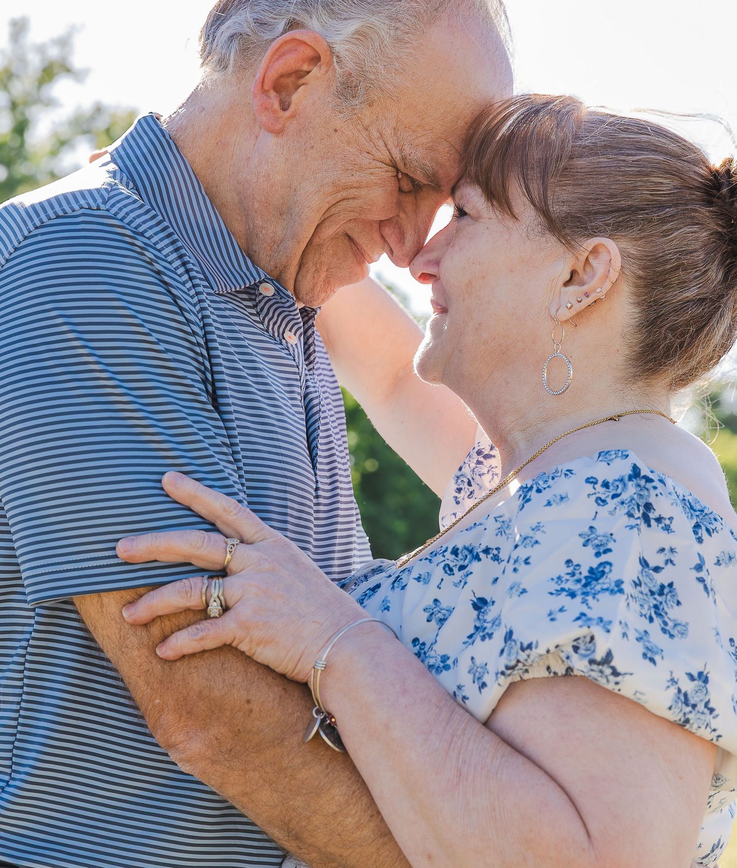 Just engaged Latino couple embracing on waterfront in Fort Monroe, Virginia