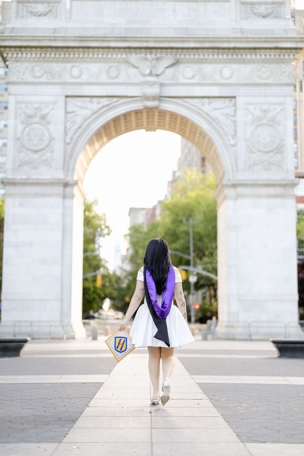 A series of photos showing a person in white and purple sitting on stone steps near an ornate archway.