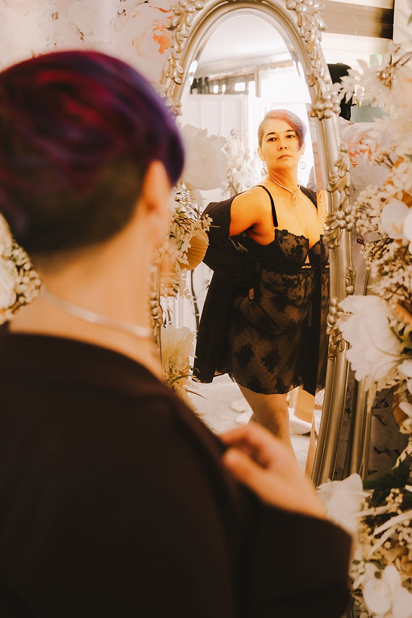 A series of warm-toned mirror reflections showing silhouettes in an intimate indoor setting with floral decorations.