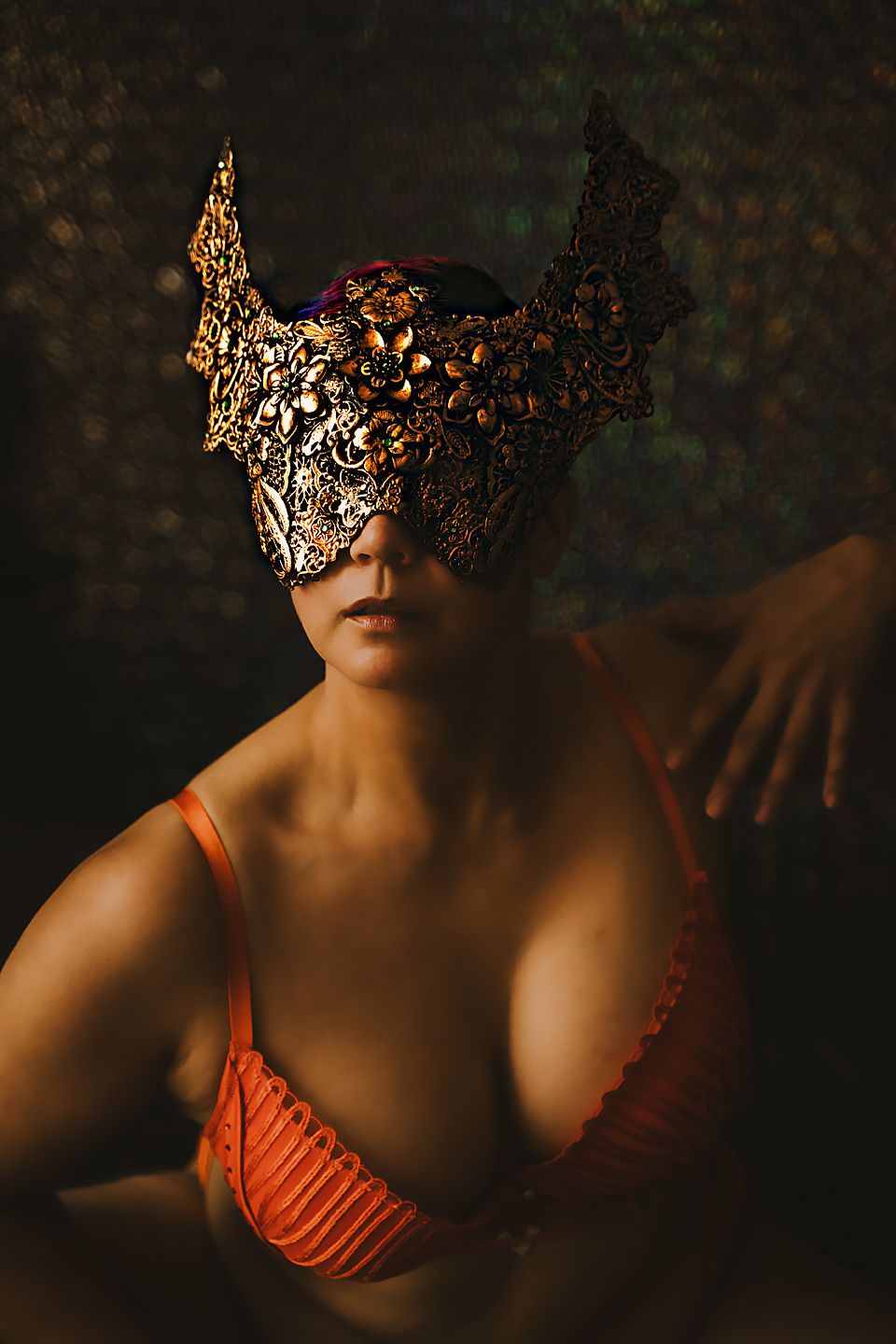 Artistic portrait series in warm tones featuring an ornate masquerade mask and coral-colored lingerie.