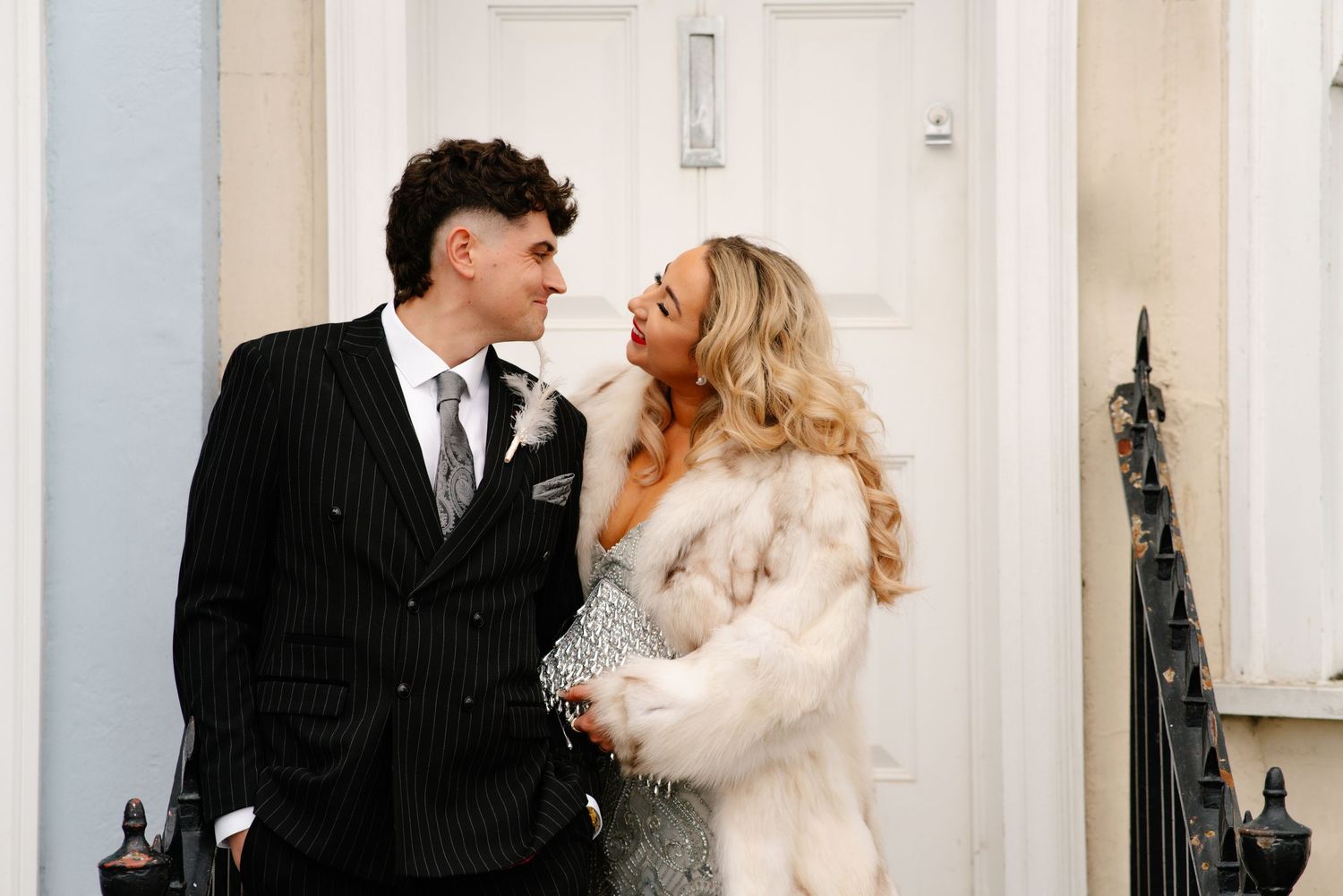 Bride and groom standing together in Weymouth by a front door during their New Year’s Eve wedding