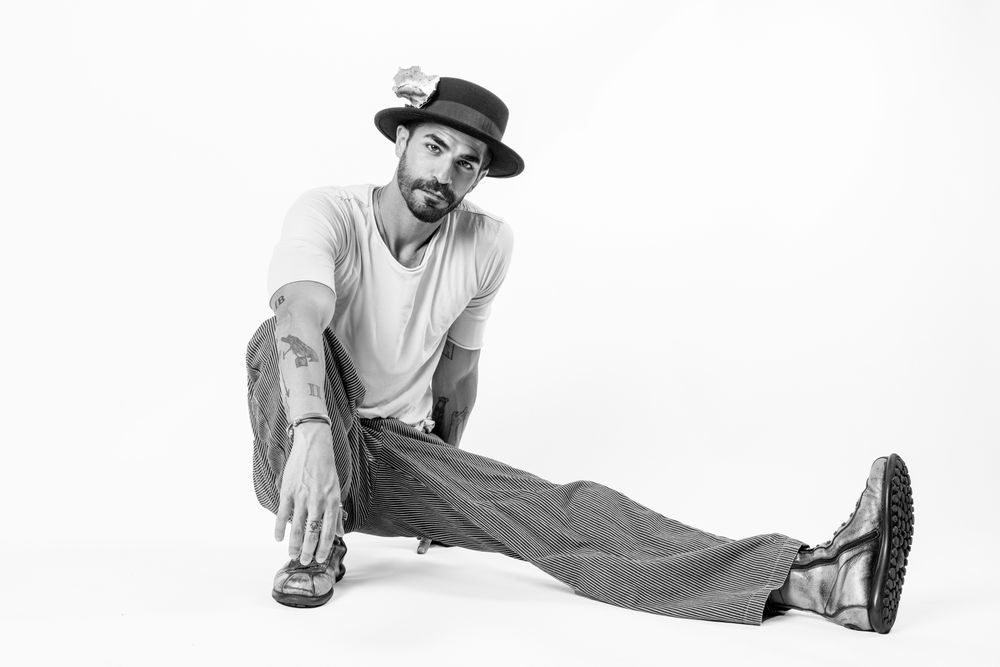 A sequence of three black and white photos showing a person stretching and performing a side split on a white background.