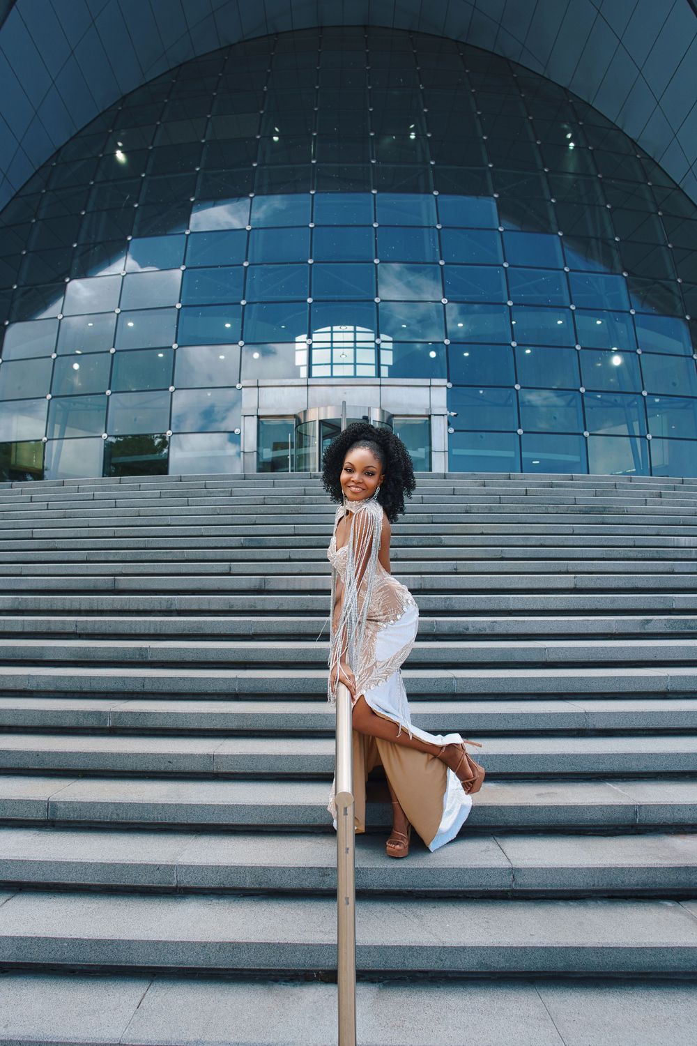 A series of photos showing someone sitting on concrete steps against a modern glass dome building structure.