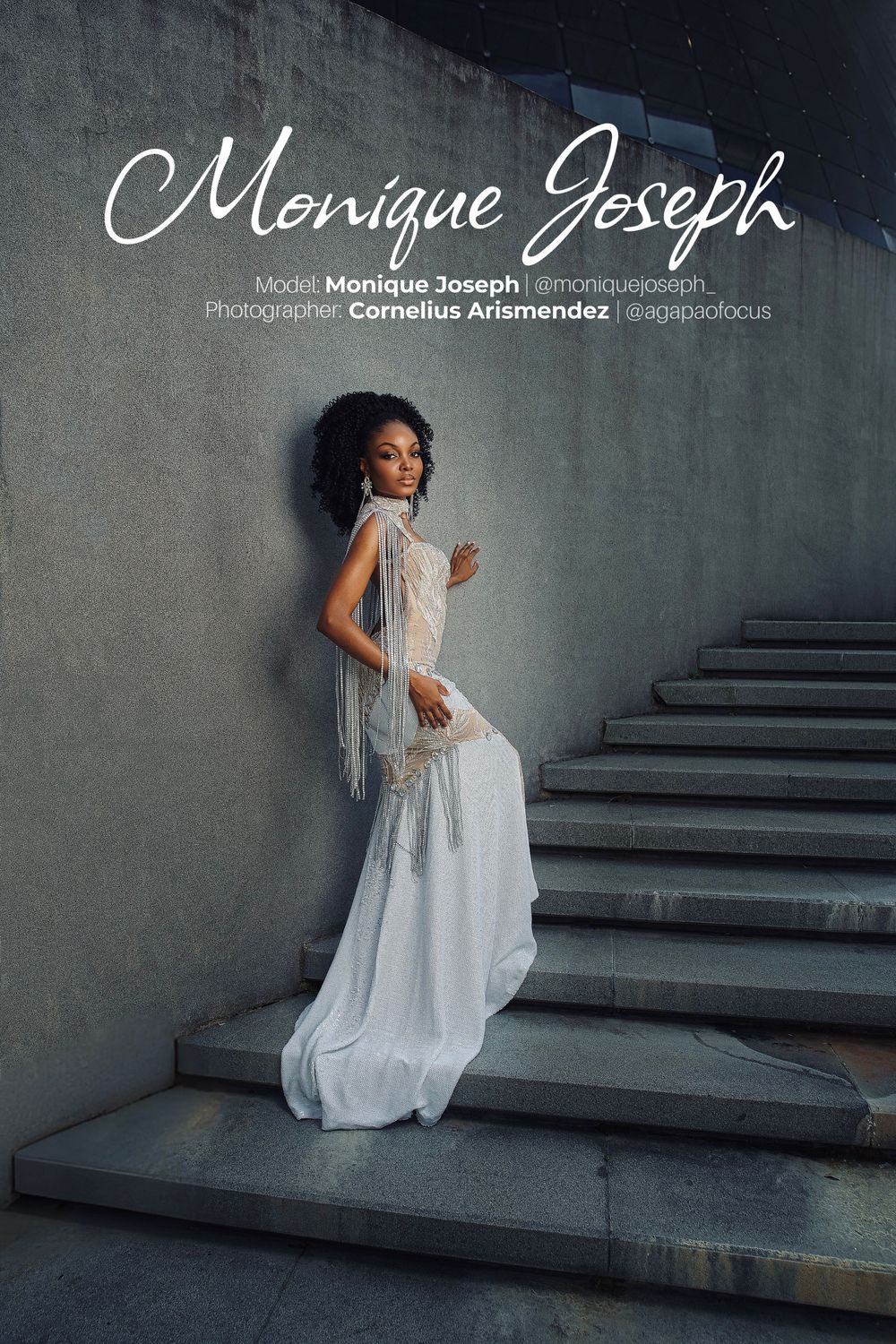 A figure in a flowing white dress poses gracefully on concrete steps against a moody gray background.