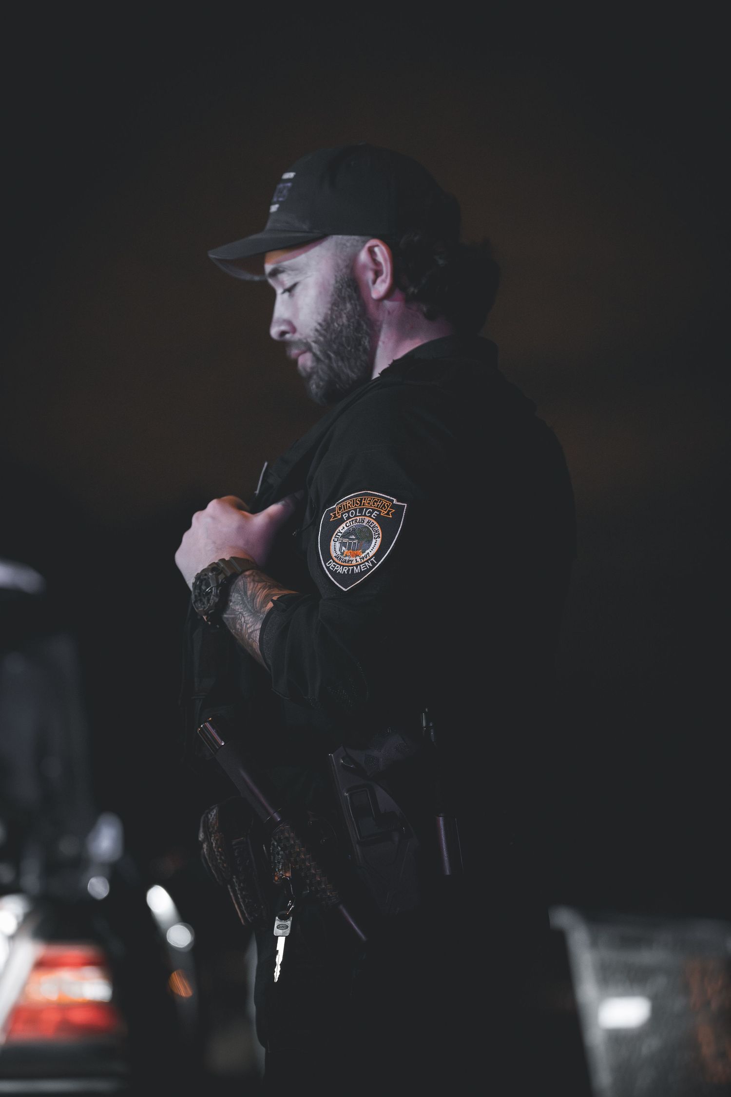 Police officers in tactical gear conducting nighttime operations.