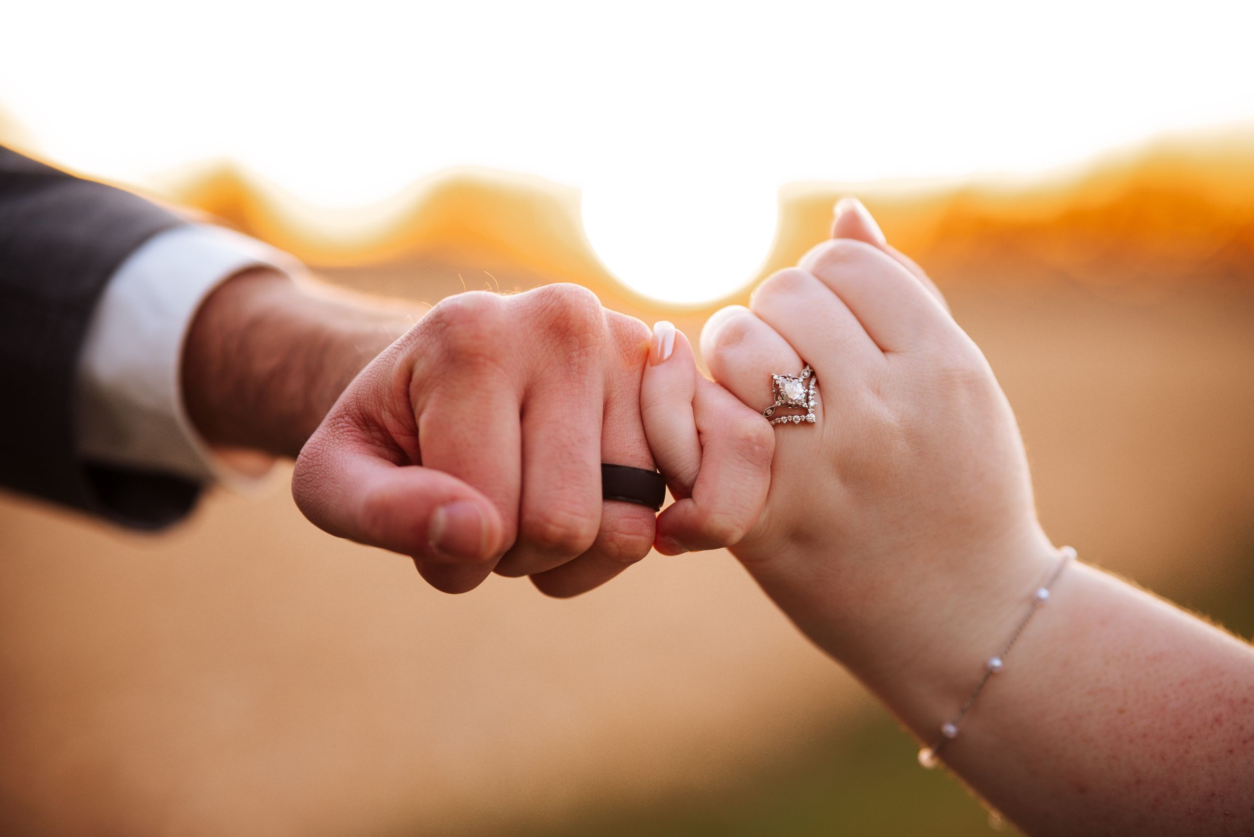 A series of wedding ring exchange photos showing hands during a marriage ceremony in warm lighting.