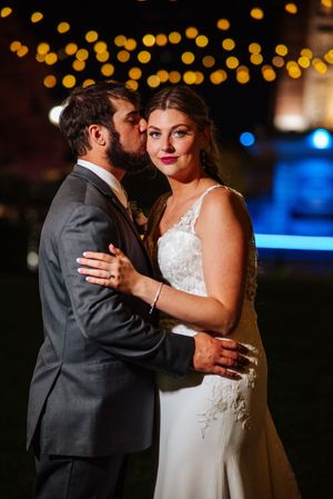 A romantic wedding photo at night with bokeh lights in the background of a couple special day at the Hilton Garden Inn in Perrysburg, Ohio.