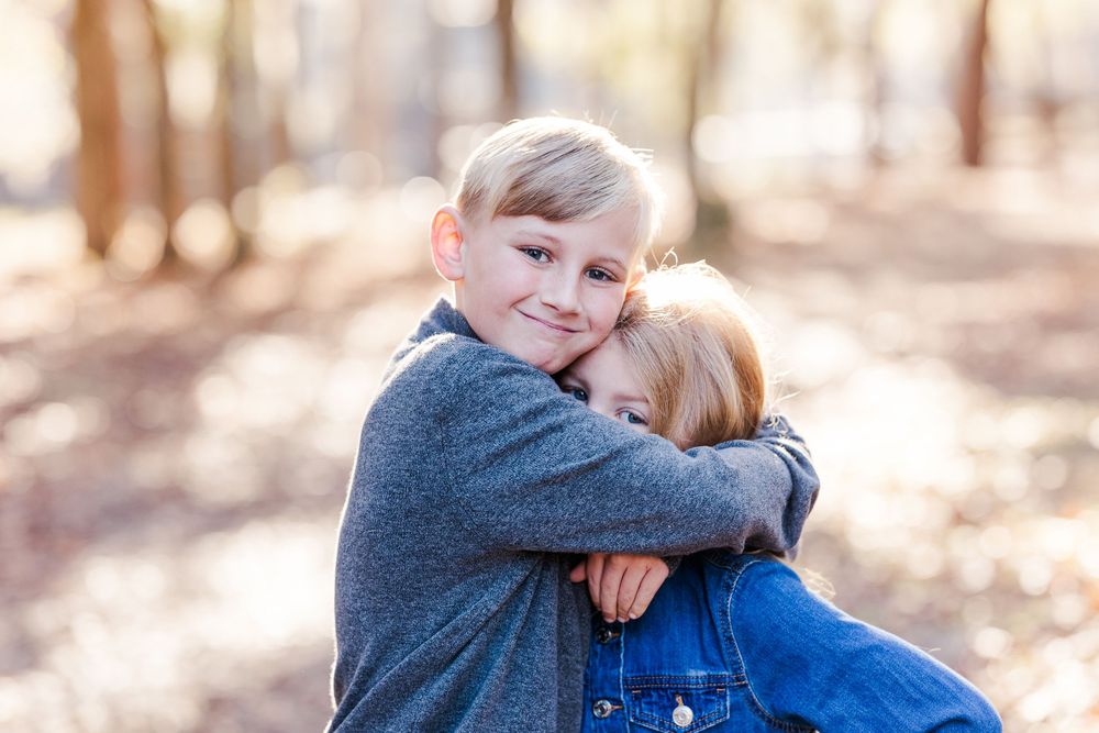 A series of candid outdoor photos showing warm embraces between parent and child in a natural setting.
