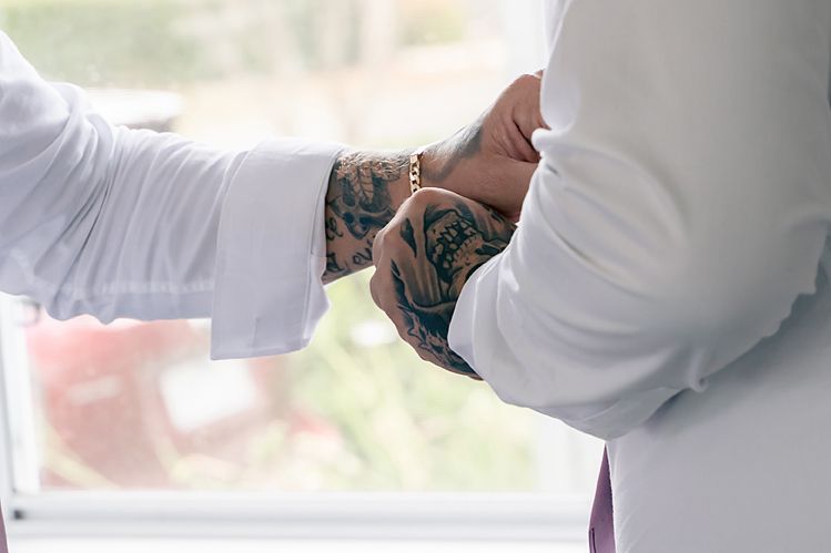 Close-up view of hands exchanging rings during a traditional wedding ceremony.