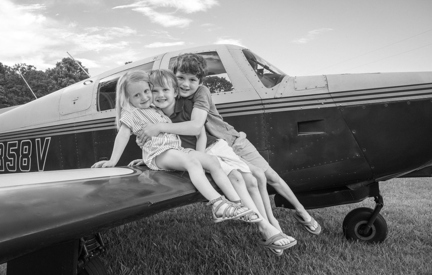 A playful family photo sequence shows people embracing and laughing together in a sunny green field.