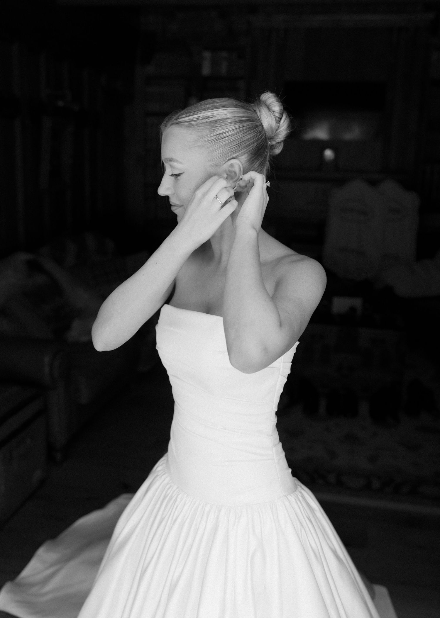 Close-up details of a classic white wedding dress with elegant fabric and styling.