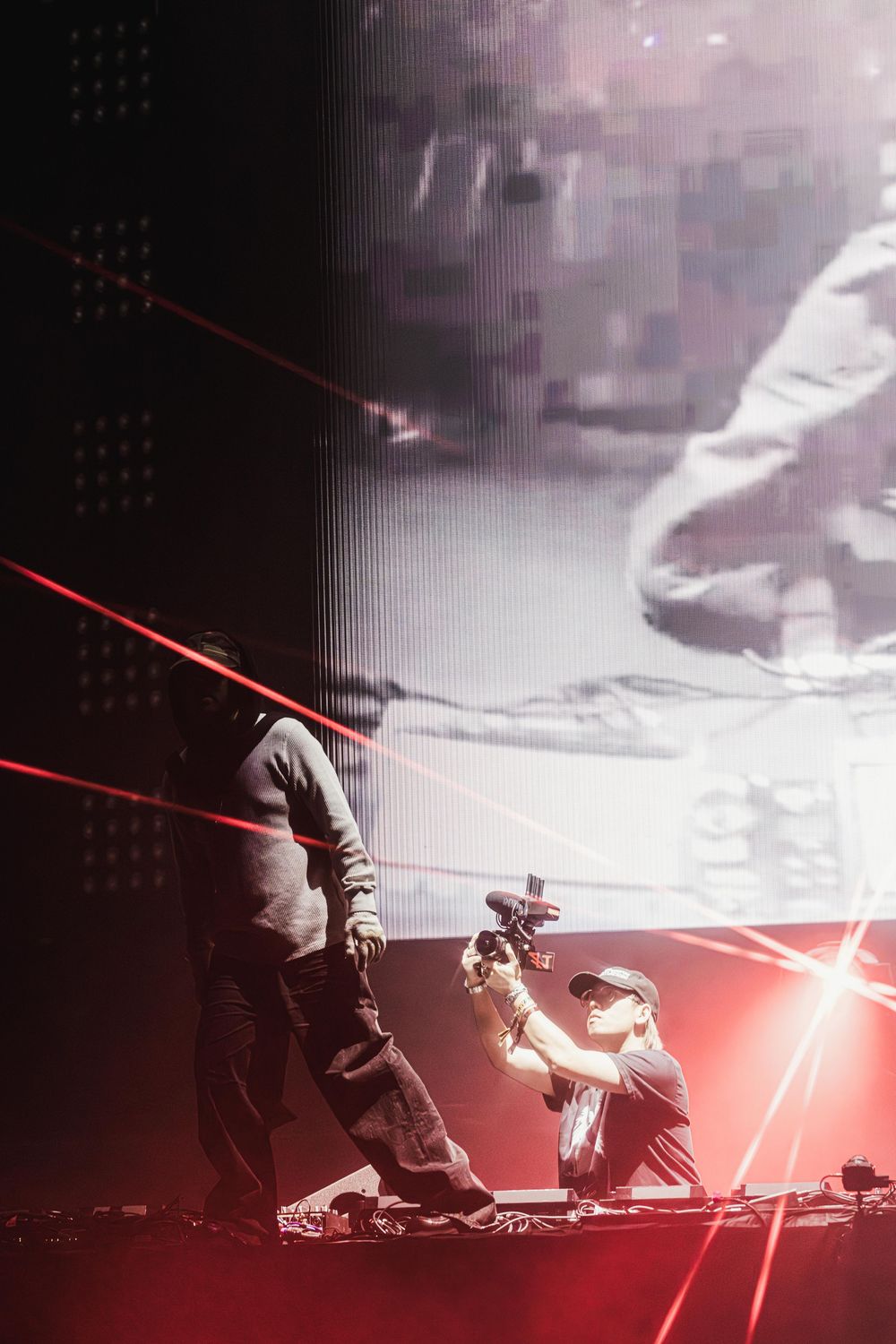 A dramatic lightsaber duel scene between two figures silhouetted against a misty dark background with red glowing effects.
